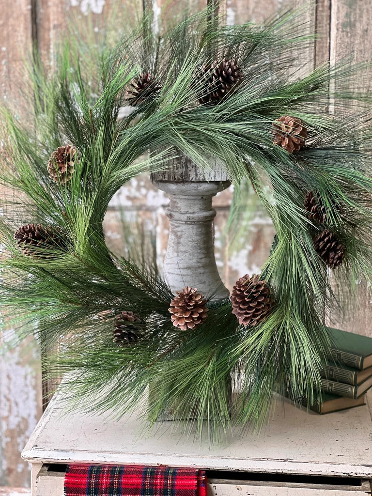 Christmas wreath with pine cones on a wooden surface